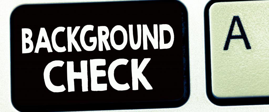Background check written on a keyboard key on a black background key