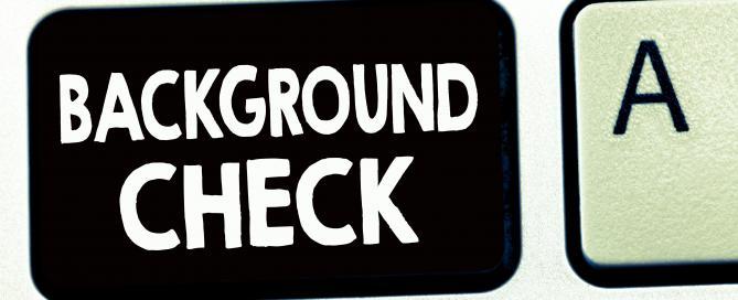 Background check written on a keyboard key on a black background key