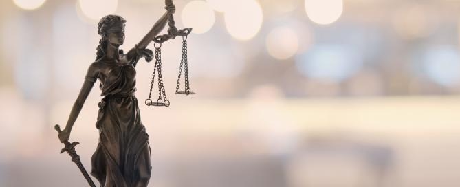 Lady justice in the forefront with blurred image