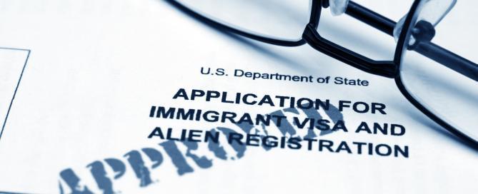 a us department of state visa application form with a pair of glasses on top