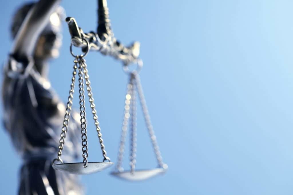 Lady justice with lady blurred out with focus on balance with blue background