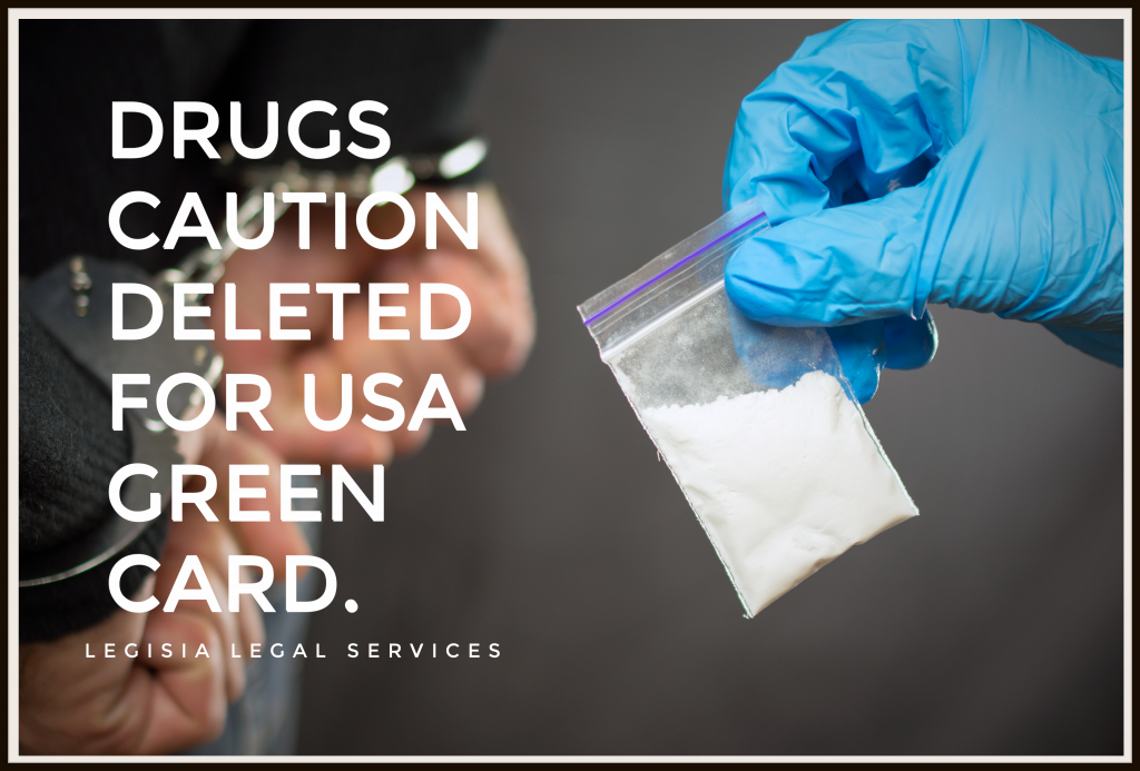 blue gloved hand holding a small packet of white substance that looks like cocaine with the words saying drugs caution deleted for usa green card. legisia legal services