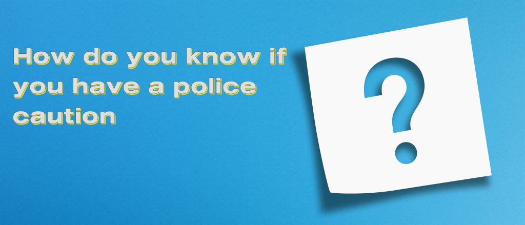 blue background with words How do you know if you have a police caution and a large white question mark
